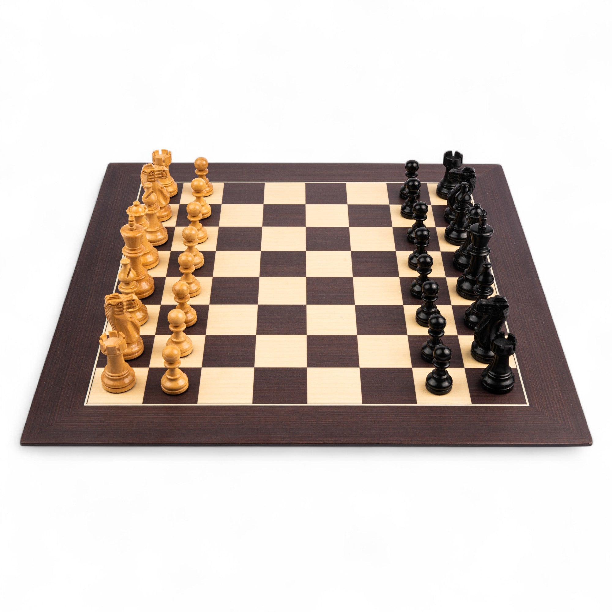 Wooden chessboard with black and white pieces on a white background