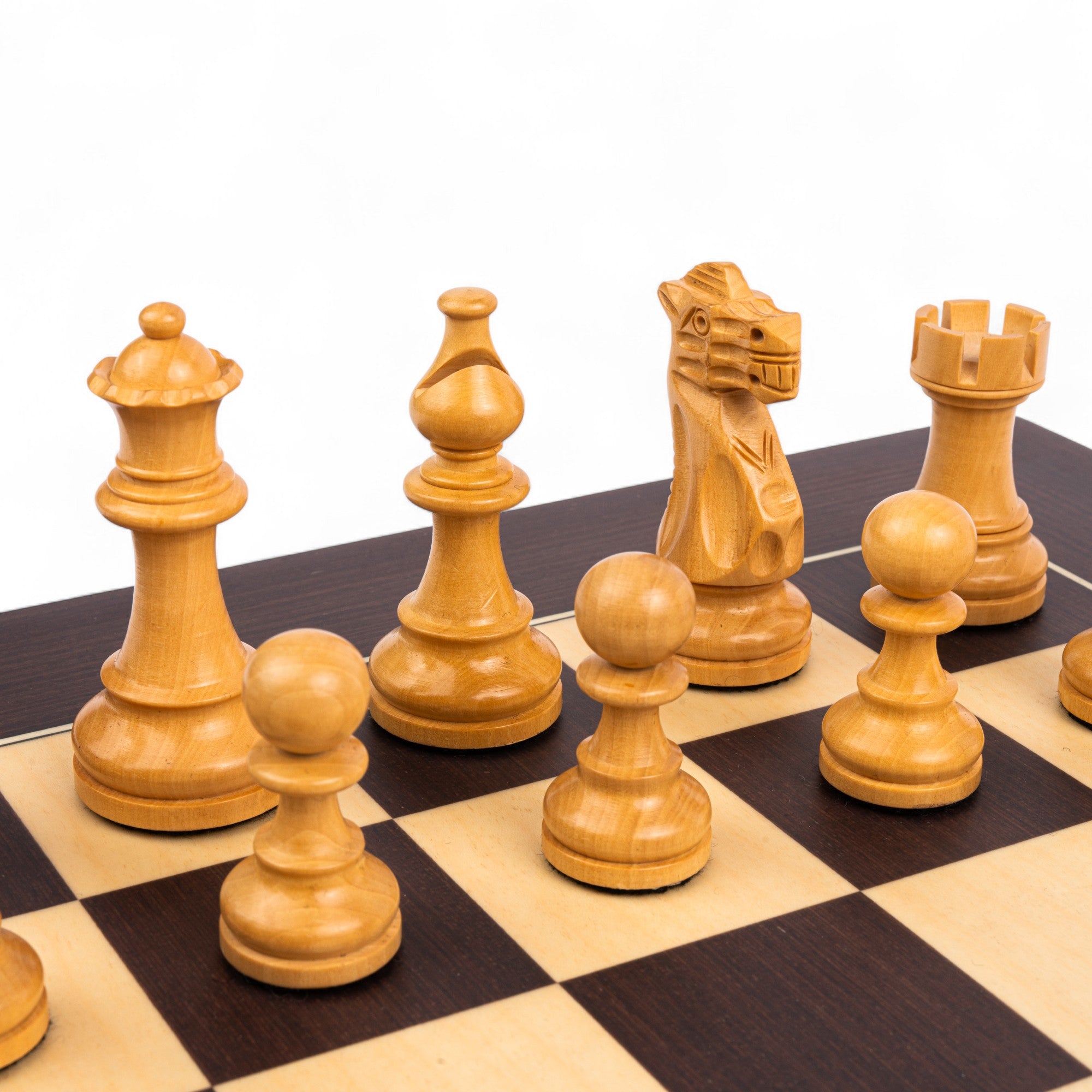 Wooden chess pieces on a chessboard with a white background