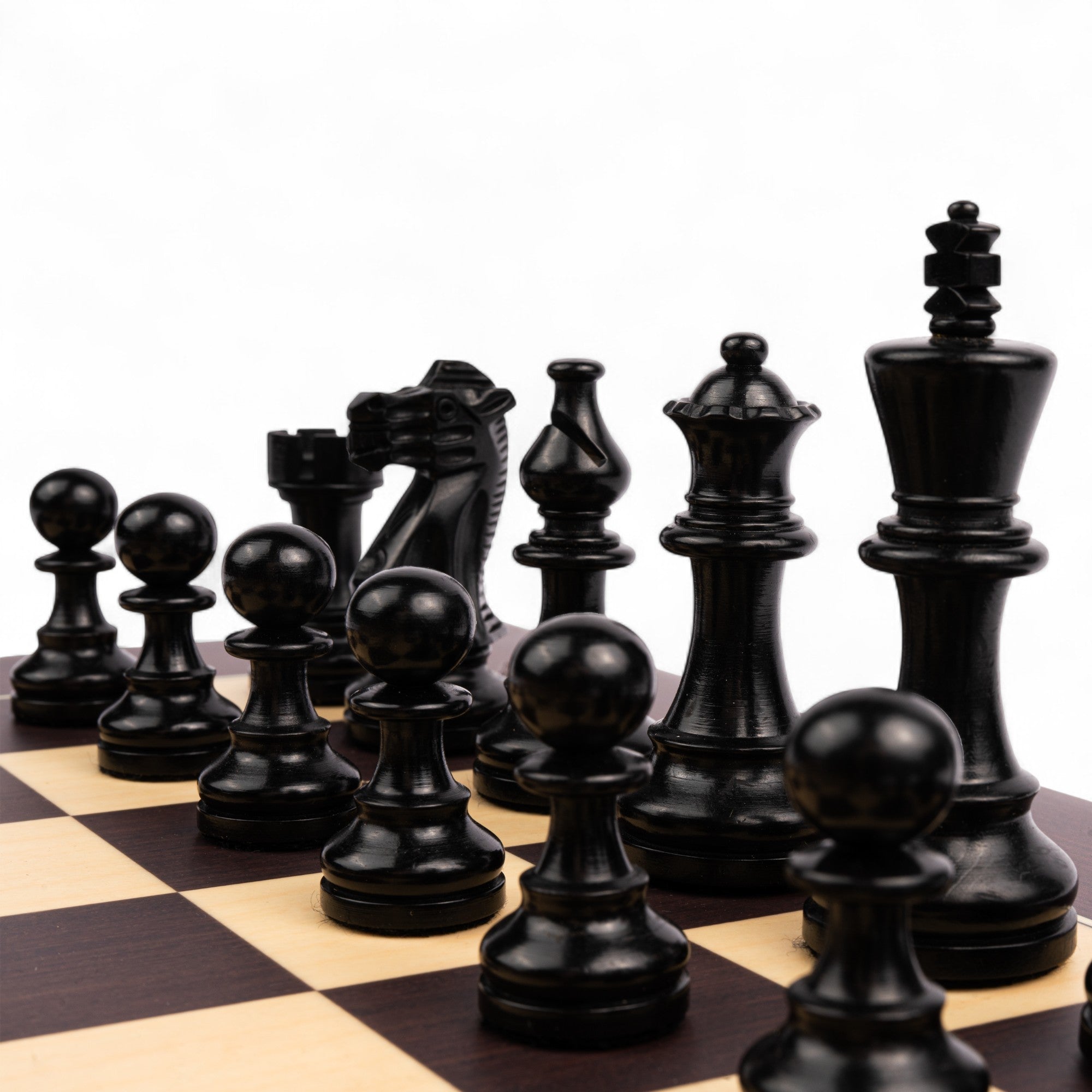 Black chess pieces on a checkered chessboard