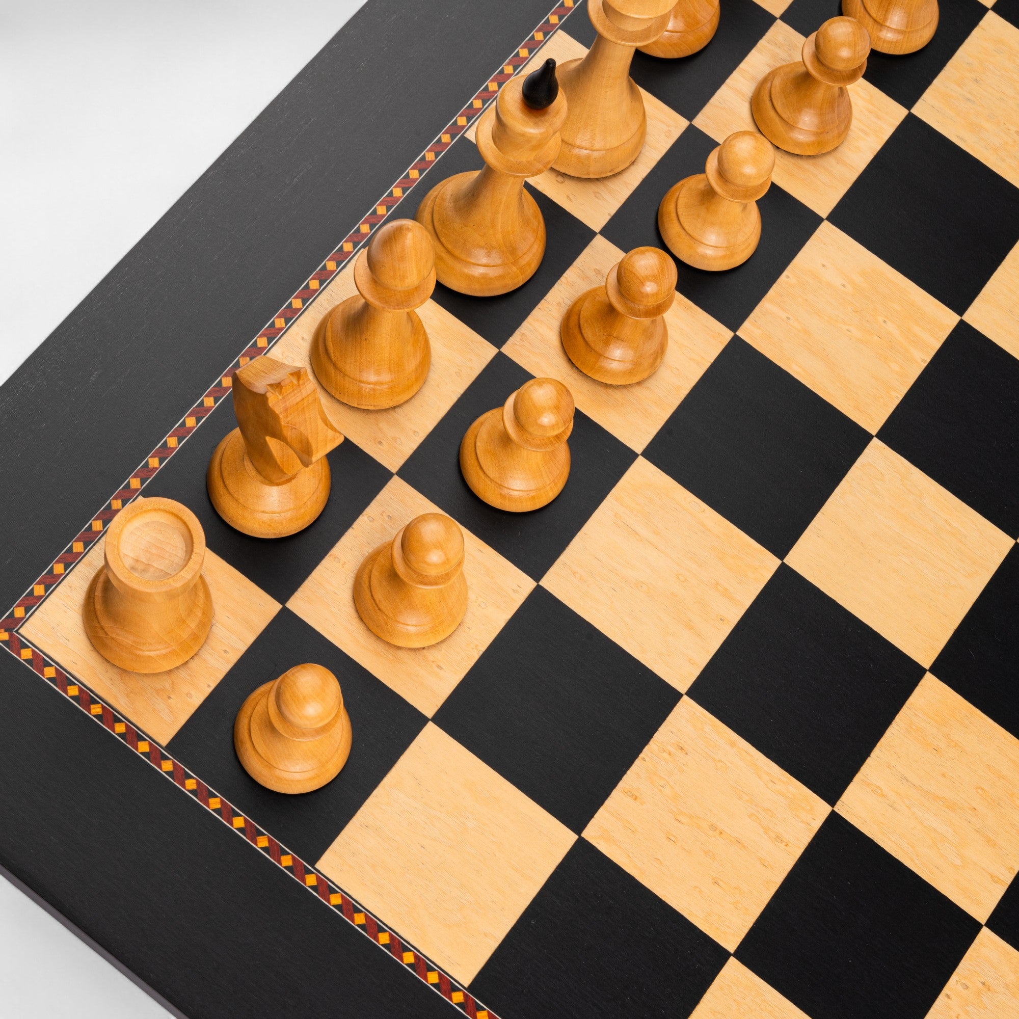 Wooden chess pieces on a checkered chessboard