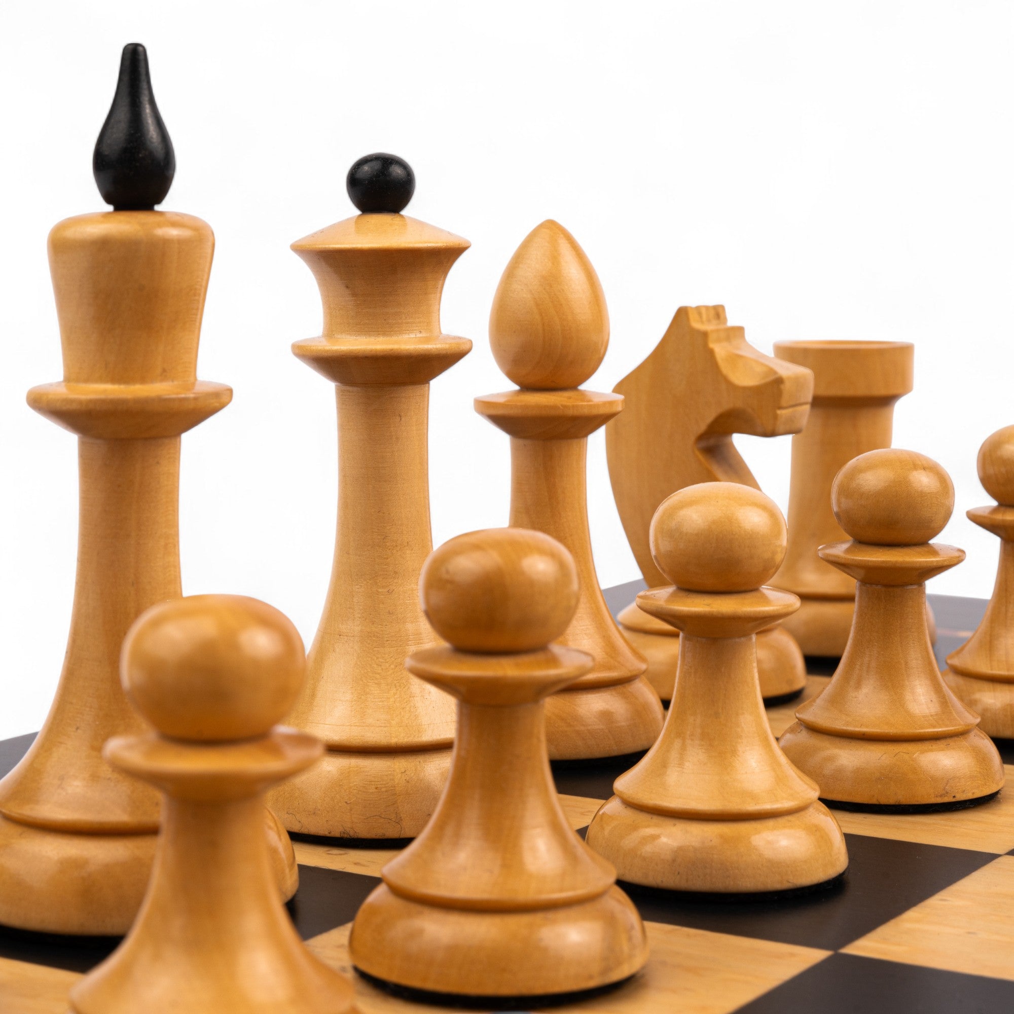 Wooden chess pieces on a checkered chessboard