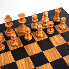 Wooden chess pieces on a checkered chessboard