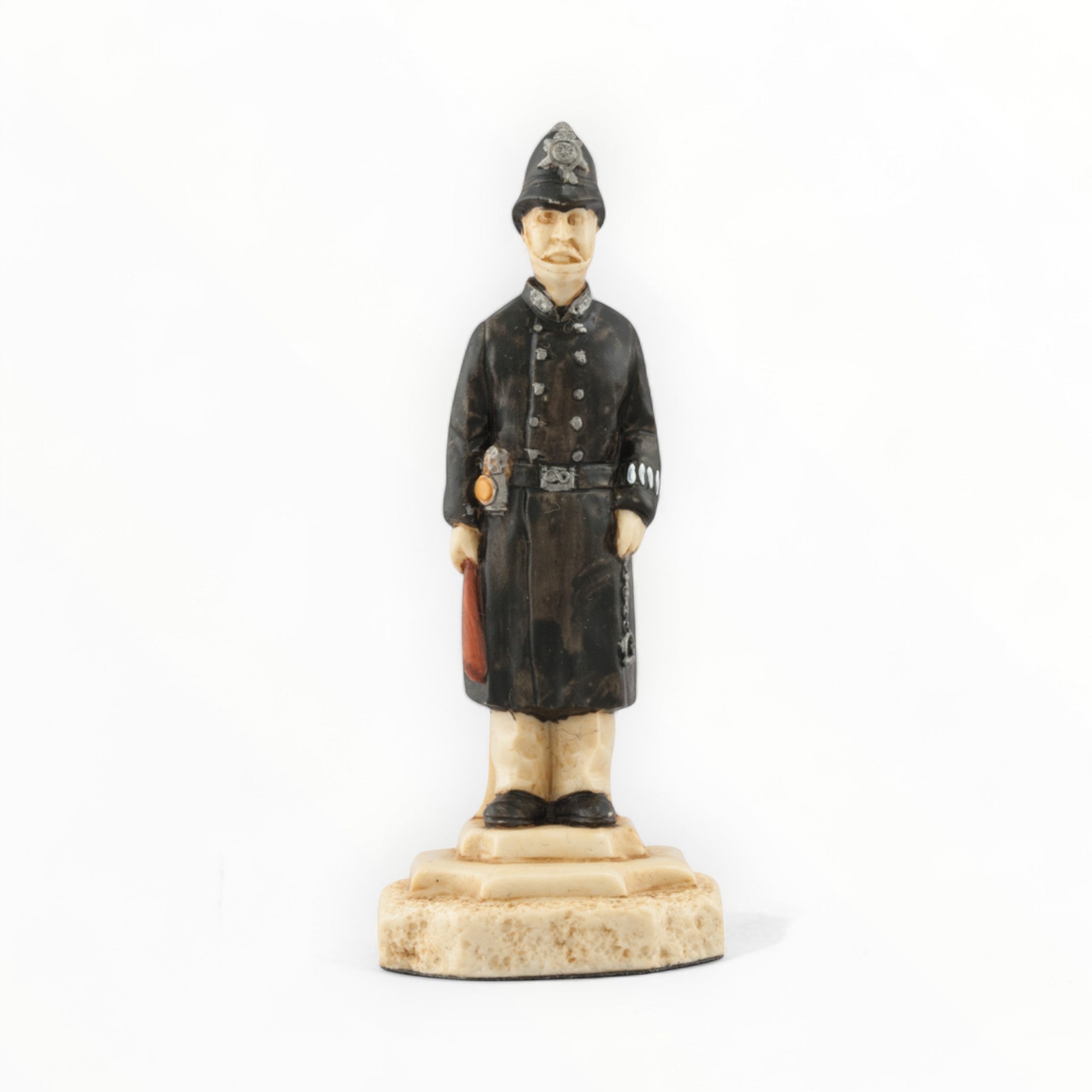 A hand painted chess piece depicting a police officer from The stories of Sherlock Holmes.